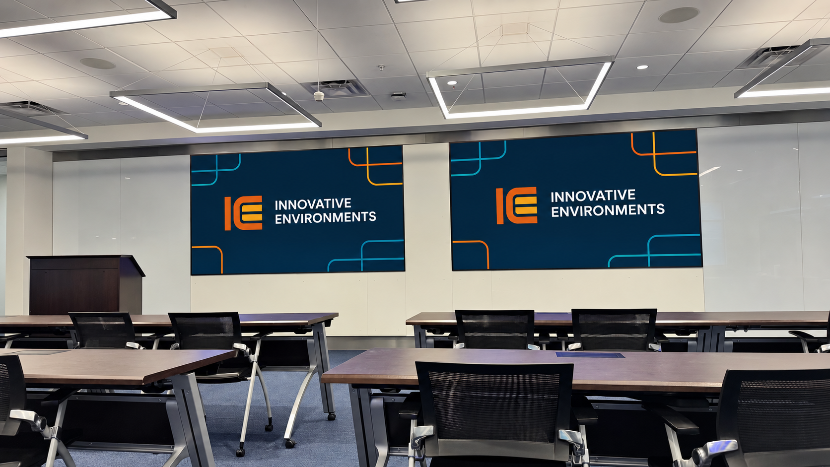 Front view of a training room with two wall-mounted presentation displays