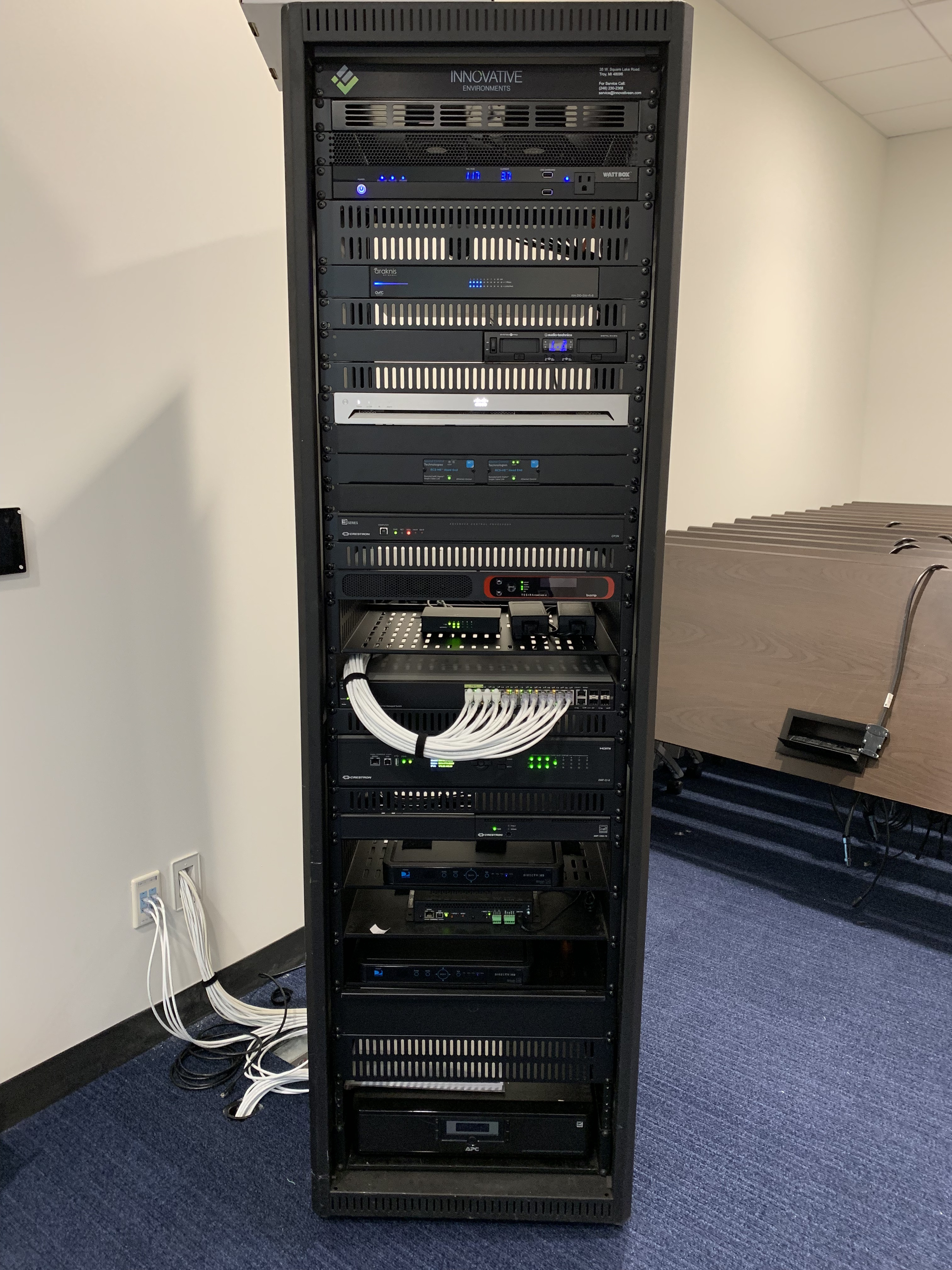 Installed audiovisual equipment rack with network connections and system components